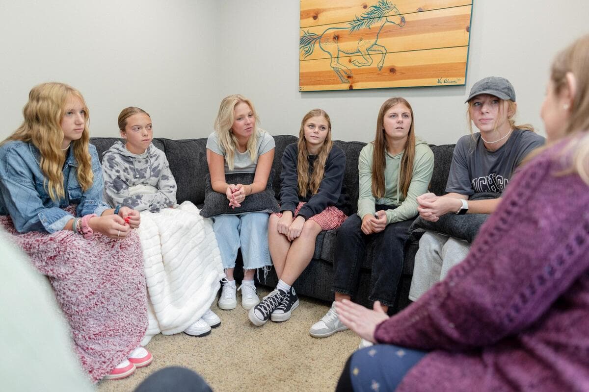 Teen girls in group therapy session at Juniper Haven